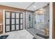 Modern bathroom with a glass-enclosed shower, wood-look accents, and contemporary fixtures at 1001 N 165Th Ave, Goodyear, AZ 85338