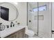 Beautiful bathroom with a walk-in shower, stylish vanity, round mirror, and modern fixtures at 1001 N 165Th Ave, Goodyear, AZ 85338