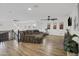 Upstairs bonus room featuring hardwood floors, cozy seating, ceiling fan, and natural light at 1001 N 165Th Ave, Goodyear, AZ 85338