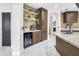 Chic kitchen bar featuring a wine fridge, shelving, and dark wood cabinetry at 1001 N 165Th Ave, Goodyear, AZ 85338