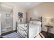 Cozy bedroom with a wrought iron bed frame, soft lighting, and a view into the ensuite bathroom at 11489 N 141St St, Scottsdale, AZ 85259