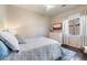 Comfortable bedroom with hardwood floors, a plush bed, and a bright window at 11489 N 141St St, Scottsdale, AZ 85259