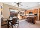 Eat-in kitchen featuring wooden cabinets, granite countertops, an island, and access to the backyard at 11489 N 141St St, Scottsdale, AZ 85259