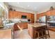 Spacious kitchen with stainless steel appliances, granite countertops, an island, and wooden cabinetry at 11489 N 141St St, Scottsdale, AZ 85259