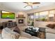 Bright living room features a fireplace, entertainment center, and sliding glass door to outdoor space at 11489 N 141St St, Scottsdale, AZ 85259