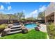 Backyard showcasing a sparkling pool with a rock waterfall feature and a raised spa area at 11489 N 141St St, Scottsdale, AZ 85259