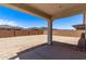 Covered patio space with ample room for outdoor seating and relaxation, overlooking a large backyard at 12374 W Marguerite Ave, Avondale, AZ 85323