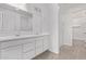 Bright bathroom featuring double sink vanity, framed mirror, walk-in shower, and wood-look floors at 12374 W Marguerite Ave, Avondale, AZ 85323