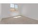 Bright bedroom featuring neutral carpet and a window with neighborhood views at 12374 W Marguerite Ave, Avondale, AZ 85323