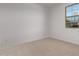 Bright bedroom with neutral carpet and a window providing natural light and neighborhood views at 12374 W Marguerite Ave, Avondale, AZ 85323