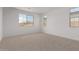 Bedroom with neutral carpet, white walls, and ample natural light from multiple windows at 12374 W Marguerite Ave, Avondale, AZ 85323