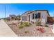 Charming single-story home with beautiful desert landscaping, a well-manicured lawn, and a welcoming front porch at 12374 W Marguerite Ave, Avondale, AZ 85323