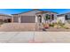 Charming single-Gathering home with a well-manicured front yard featuring desert landscaping and a brick driveway at 12374 W Marguerite Ave, Avondale, AZ 85323