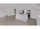 Open-concept kitchen with stainless appliances, a center island, and sleek white cabinetry at 12374 W Marguerite Ave, Avondale, AZ 85323