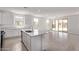 Spacious kitchen open to the living area, featuring a center island and sliding glass doors to the patio at 12374 W Marguerite Ave, Avondale, AZ 85323
