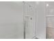 Walk-in shower with glass door, chrome fixtures, and convenient corner shelving at 12374 W Marguerite Ave, Avondale, AZ 85323