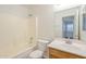 Bright bathroom with a combination bathtub and shower, complemented by a clean vanity and toilet at 13011 W Mandalay Ln, El Mirage, AZ 85335