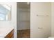 Bathroom with vanity leading to open closet with shelving for optimal storage solutions at 13011 W Mandalay Ln, El Mirage, AZ 85335