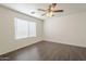 Bedroom featuring a ceiling fan, window, and wood laminate flooring at 13011 W Mandalay Ln, El Mirage, AZ 85335