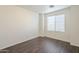 Bright bedroom with wood flooring featuring a window with coverings at 13011 W Mandalay Ln, El Mirage, AZ 85335