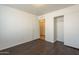 Bright bedroom featuring wood-look floors and a closet with sliding doors at 13011 W Mandalay Ln, El Mirage, AZ 85335