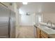 A kitchen view with granite countertops, stainless steel appliances, and tiled floors at 13011 W Mandalay Ln, El Mirage, AZ 85335