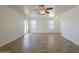 Bright living room featuring tile flooring, ceiling fan, and access to the backyard at 13011 W Mandalay Ln, El Mirage, AZ 85335