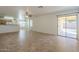 Bright living room with tile flooring, ceiling fan, and sliding glass doors to the backyard at 13011 W Mandalay Ln, El Mirage, AZ 85335