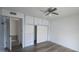 Bedroom with light wood floors, plenty of storage and drawers, and view into adjacent room at 13816 N 103Rd Ave, Sun City, AZ 85351