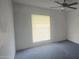 Neutral bedroom features soft carpeting, natural light, and a modern ceiling fan at 13816 N 103Rd Ave, Sun City, AZ 85351