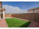 Spacious backyard with artificial turf, gravel landscaping, and a block fence at 14377 W Alameda Rd, Surprise, AZ 85387