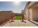 An outdoor backyard with bright pink Adirondack chairs sitting on the patio at 14377 W Alameda Rd, Surprise, AZ 85387