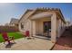 Patio area with outdoor grill, patio furniture, rock landscaping, and artificial grass at 14377 W Alameda Rd, Surprise, AZ 85387