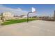 Enjoy a game of basketball on the community court with a manicured lawn and beautiful homes in the background at 14377 W Alameda Rd, Surprise, AZ 85387