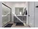 Modern bathroom featuring double sinks, gray cabinets, large mirror, and a glass enclosed shower at 14377 W Alameda Rd, Surprise, AZ 85387