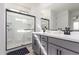 Modern bathroom with a glass-enclosed shower and double sink vanity at 14377 W Alameda Rd, Surprise, AZ 85387