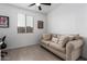 Comfortable bedroom featuring a beige sofa with decorative pillows near a window at 14377 W Alameda Rd, Surprise, AZ 85387