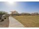 Landscaped community park featuring a walking path, lush lawns, and covered seating areas for residents at 14377 W Alameda Rd, Surprise, AZ 85387