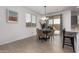 Bright dining area featuring a window for natural light, modern chandelier, and backyard access at 14377 W Alameda Rd, Surprise, AZ 85387