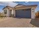 Attractive single-story home with a two-car garage, paver driveway, and desert landscaping at 14377 W Alameda Rd, Surprise, AZ 85387