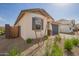 Attractive single-story home with a two-car garage, desert landscaping, and block fencing at 14377 W Alameda Rd, Surprise, AZ 85387