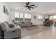 Bright living room featuring wood look tile, recessed lighting, ceiling fan, and open concept floorplan at 14377 W Alameda Rd, Surprise, AZ 85387