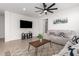 Bright living room with a ceiling fan, recessed lighting, and a cozy couch at 14377 W Alameda Rd, Surprise, AZ 85387