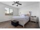 Calm main bedroom features a ceiling fan, neutral walls, and a comfortable bed at 14377 W Alameda Rd, Surprise, AZ 85387