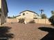 A well-sized backyard featuring neutral landscaping, block wall, mature plants and playset at 14435 W Verde Ln, Goodyear, AZ 85395