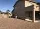 Side yard showing neutral landscaping, covered patio area, block wall and exterior of the home at 14435 W Verde Ln, Goodyear, AZ 85395