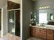 Bathroom with a shower, tiled floor and vanity with dark wood cabinetry and a light countertop at 14435 W Verde Ln, Goodyear, AZ 85395