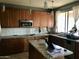 Kitchen with stainless steel appliances, tiled backsplash, and a granite countertop island at 14435 W Verde Ln, Goodyear, AZ 85395