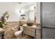 Modern bathroom features a stone tile accent wall, a unique sink, and stylish fixtures at 15377 W Cheery Lynn Rd, Goodyear, AZ 85395