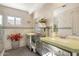 Elegant bathroom with double sinks, decorative mirrors, white tile walls and green accent stripe at 15377 W Cheery Lynn Rd, Goodyear, AZ 85395